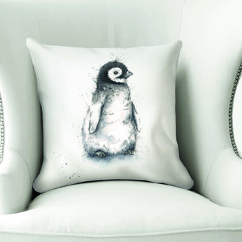 Baby Penguin Cushion by Beverley Fisher on a chair
