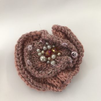Pink knitted brooch with various coloured beads by Christine Kolinsky